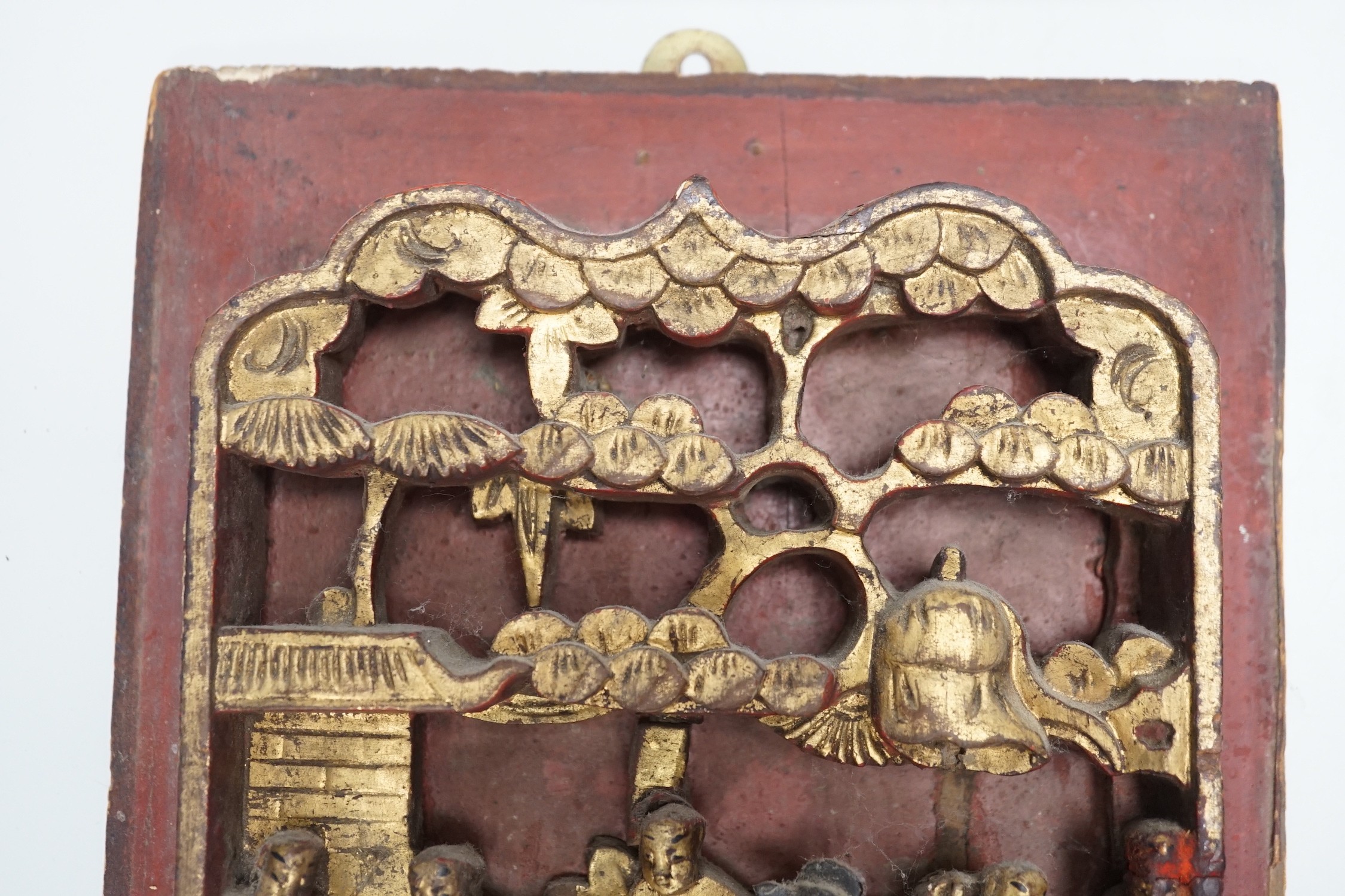 Three Chinese gilded and lacquered wood figural panels and two similar dragon and phoenix crest pieces (5), late 19th century
